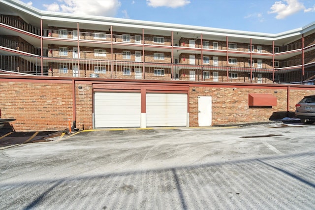 view of building exterior with an attached garage and aphalt driveway