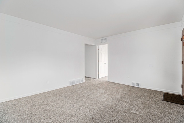 unfurnished room featuring baseboards, visible vents, and carpet flooring