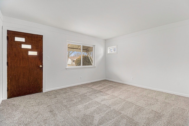 carpeted entrance foyer featuring baseboards