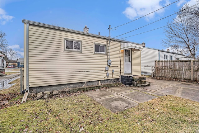 back of house with a patio area and fence