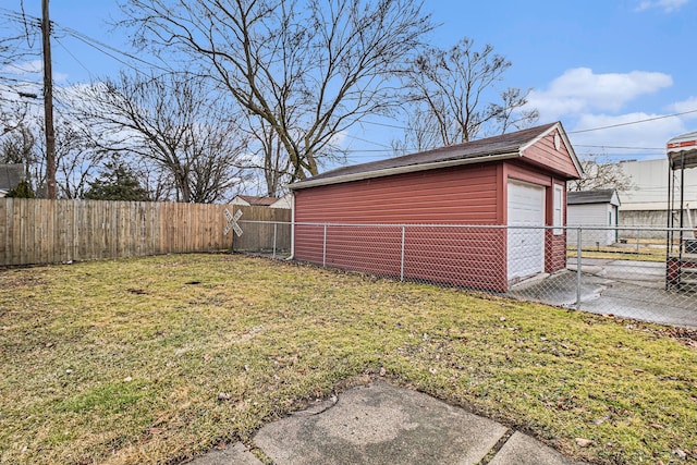 detached garage featuring driveway and fence