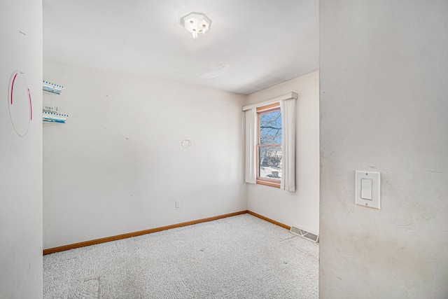 carpeted spare room featuring visible vents and baseboards