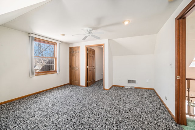 additional living space featuring visible vents, baseboards, carpet, and ceiling fan