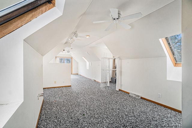 bonus room with lofted ceiling, baseboards, and visible vents