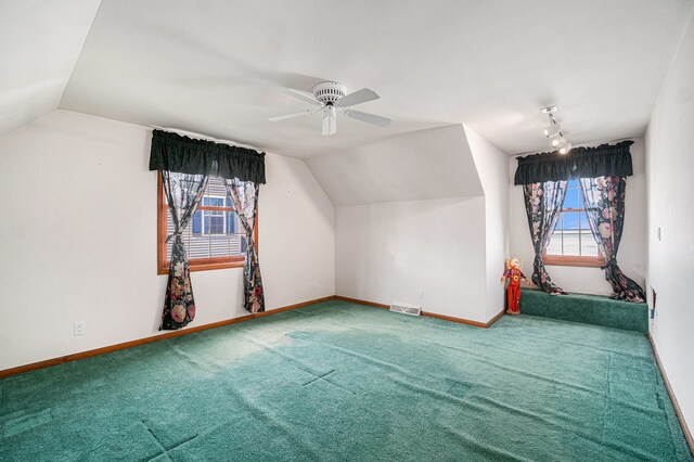 bonus room with carpet flooring, plenty of natural light, visible vents, and ceiling fan