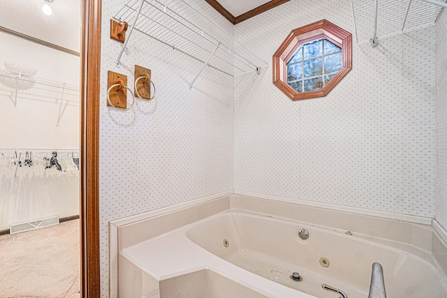 full bathroom with a spacious closet, visible vents, a jetted tub, and wallpapered walls