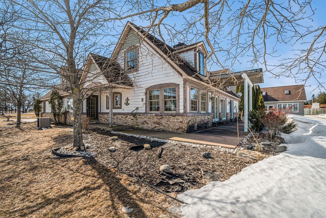 view of home's exterior featuring brick siding and a chimney