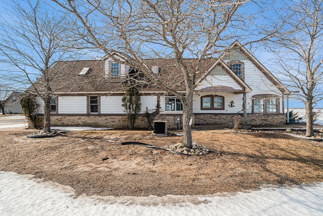 view of front of home featuring brick siding and central AC unit