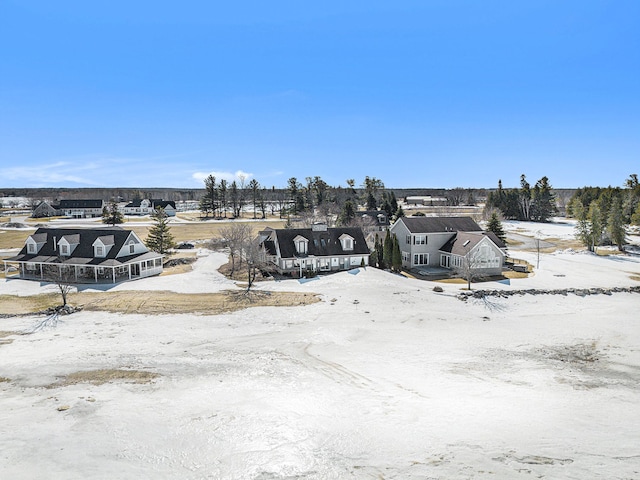 snowy aerial view with a residential view