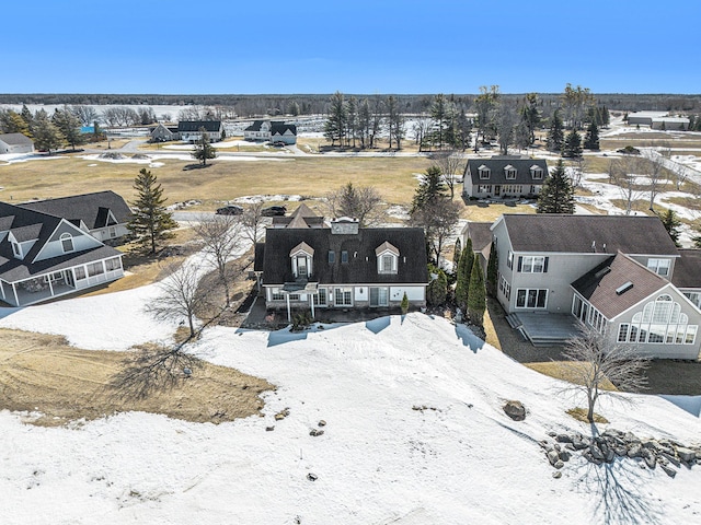 snowy aerial view featuring a residential view