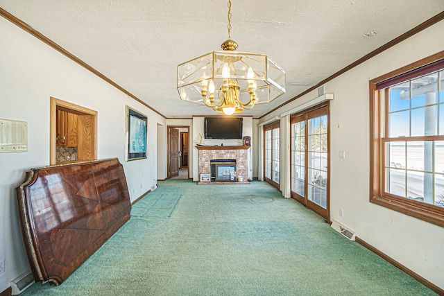 living area featuring a textured ceiling, carpet, visible vents, and a chandelier
