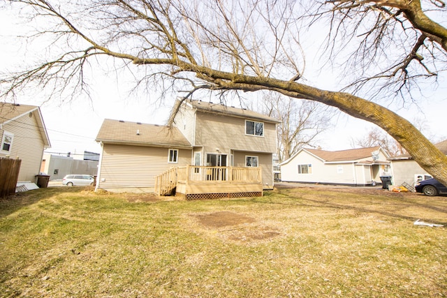 back of property featuring a deck and a lawn