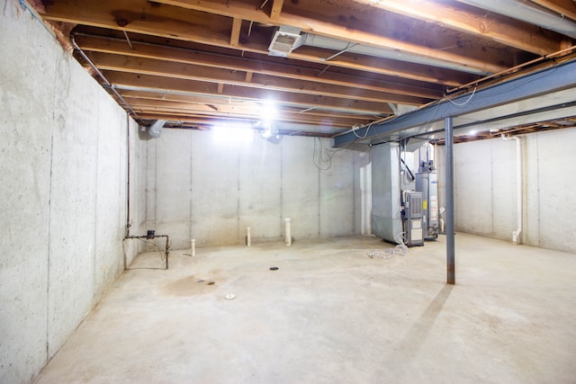 unfinished below grade area with heating unit and water heater