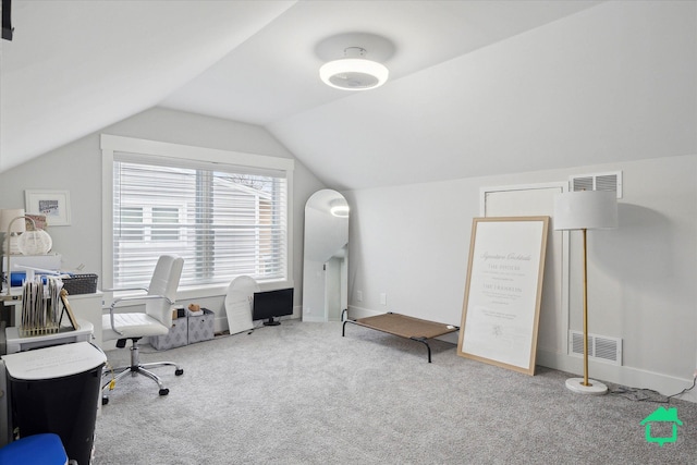 carpeted home office with vaulted ceiling, visible vents, and baseboards