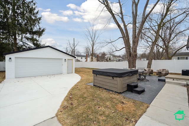 view of yard with fence private yard, a detached garage, and an outdoor structure