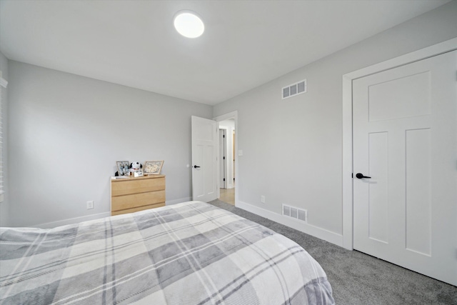 carpeted bedroom with visible vents and baseboards
