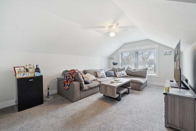 carpeted living room with baseboards, lofted ceiling, and a ceiling fan