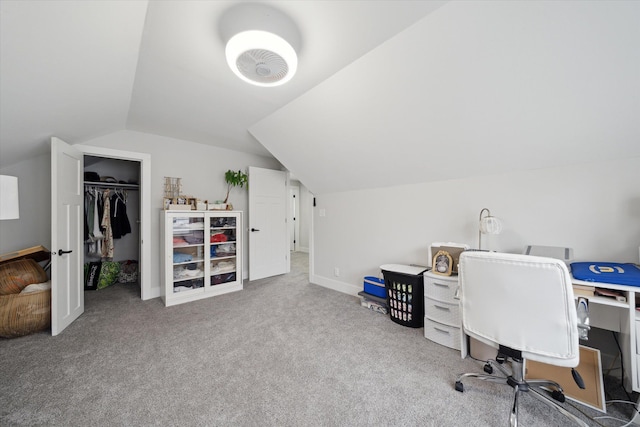 carpeted office space with vaulted ceiling and baseboards