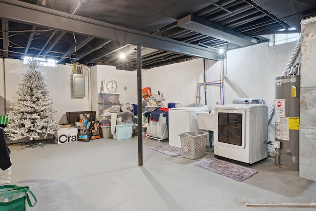 below grade area featuring washer and dryer, electric panel, and water heater