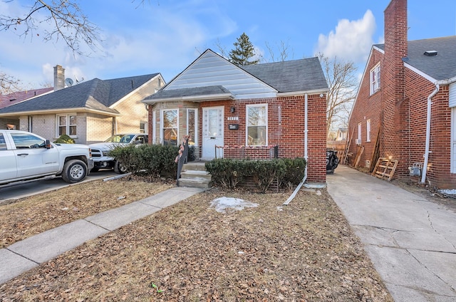 bungalow-style house featuring brick siding