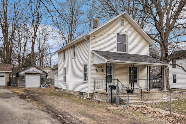 view of front facade featuring aphalt driveway, a chimney, fence, a garage, and an outdoor structure