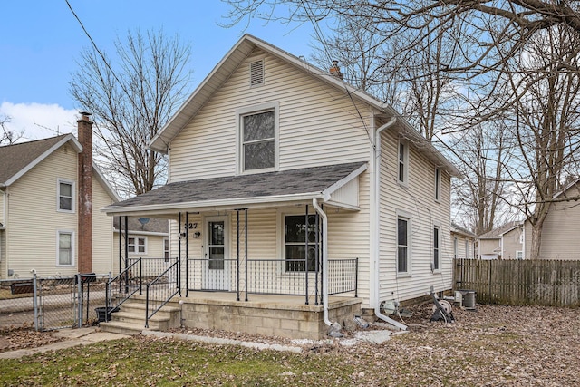 view of front facade with a porch, a gate, and fence