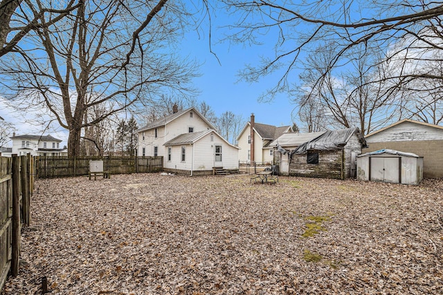 view of yard with an outbuilding, a shed, and a fenced backyard