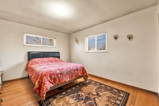 bedroom featuring light wood-type flooring and baseboards