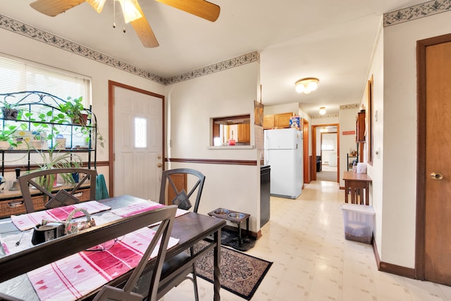 dining area featuring light floors and baseboards