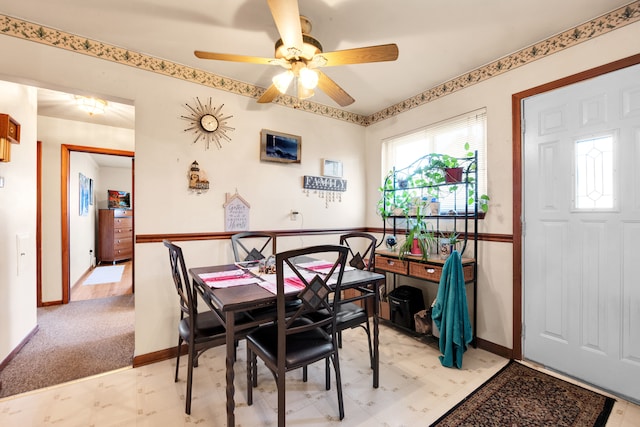 dining room featuring light carpet and baseboards