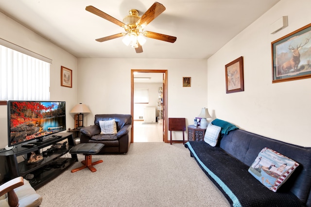 carpeted living area featuring a ceiling fan