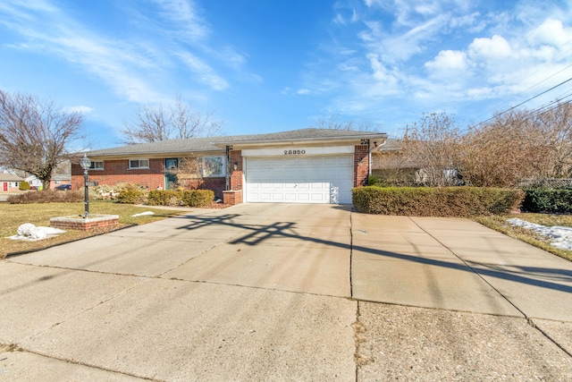 ranch-style home featuring brick siding, driveway, and an attached garage