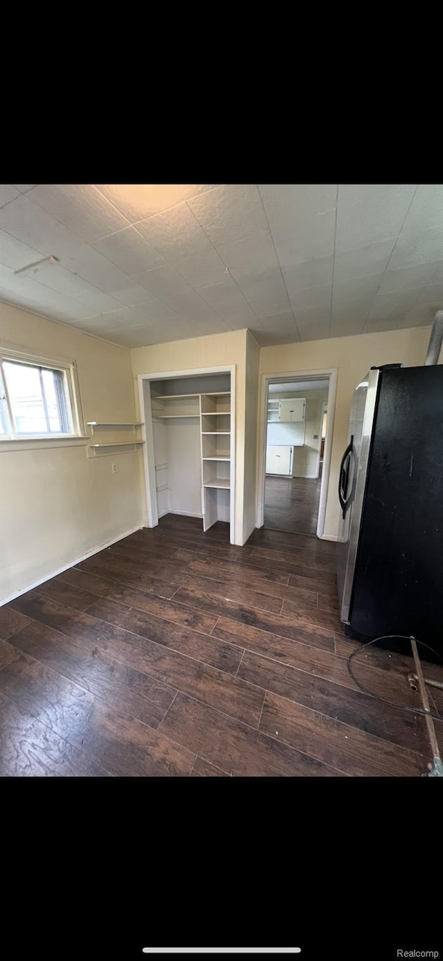 1531 Gilbert St, Saginaw, MI 48602 - bedroom featuring stainless steel fridge, dark wood finished floors, and a closet