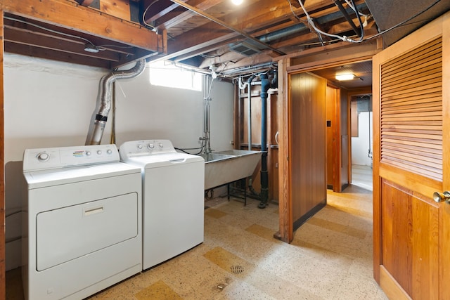 laundry room with laundry area, a sink, light floors, and separate washer and dryer