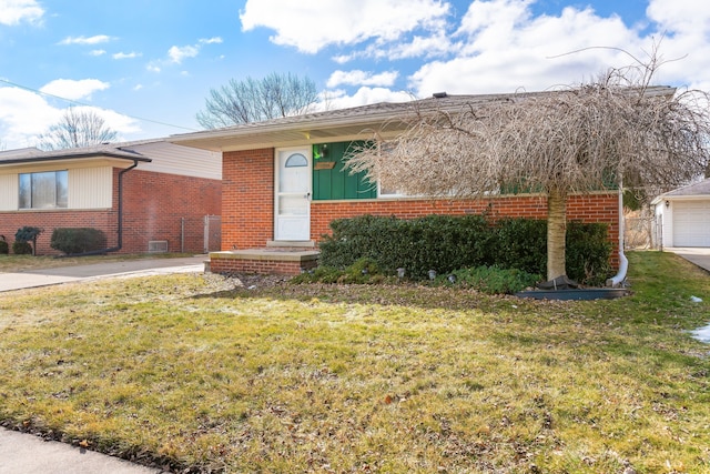 ranch-style house with a front yard and brick siding