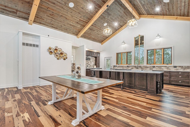 interior space with high vaulted ceiling, hardwood / wood-style floors, beamed ceiling, and wooden ceiling