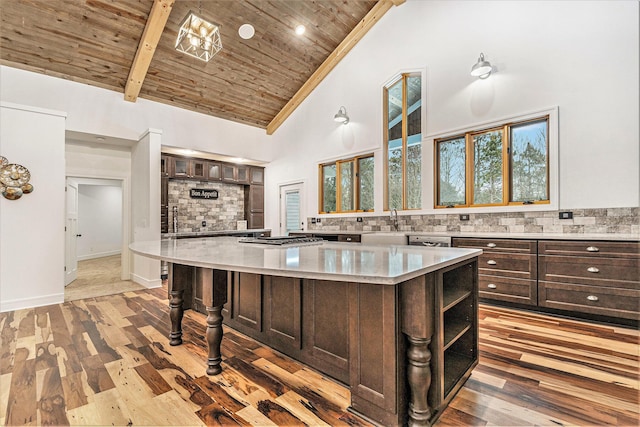 kitchen featuring dark brown cabinetry, wooden ceiling, high vaulted ceiling, and decorative backsplash