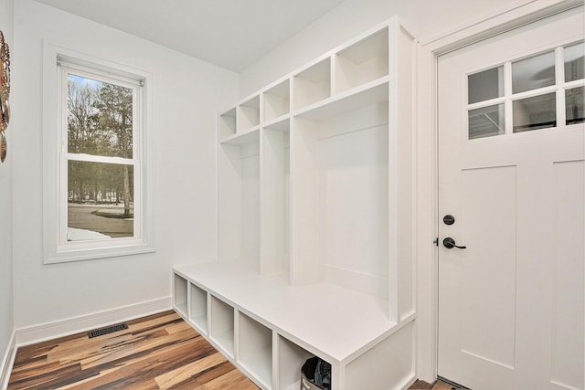 mudroom with visible vents, baseboards, and wood finished floors