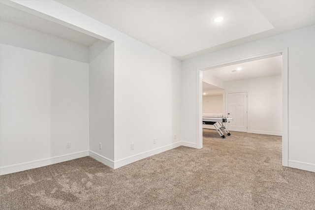 spare room featuring carpet and baseboards