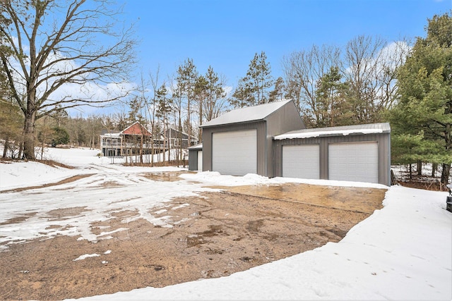 exterior space with a detached garage and an outdoor structure