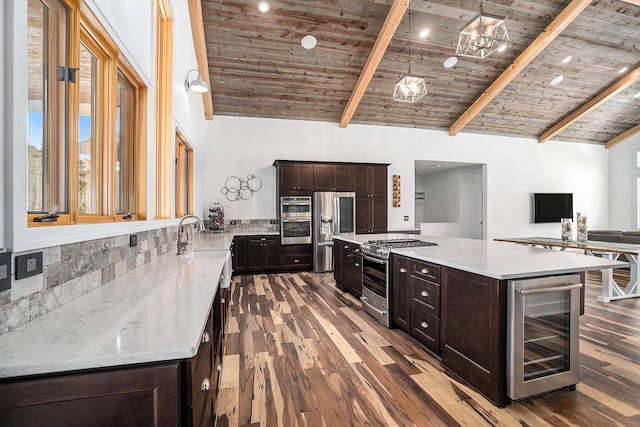 kitchen featuring lofted ceiling with beams, wooden ceiling, beverage cooler, wood finished floors, and appliances with stainless steel finishes