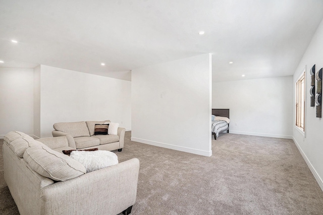 living area with carpet, baseboards, and recessed lighting