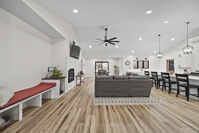 7450 Sears Rd, Horton, MI 49246 - living room with recessed lighting, a fireplace, light wood-style flooring, and ceiling fan