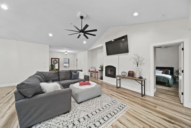 7450 Sears Rd, Horton, MI 49246 - living room with a ceiling fan, a glass covered fireplace, lofted ceiling, light wood-style floors, and recessed lighting