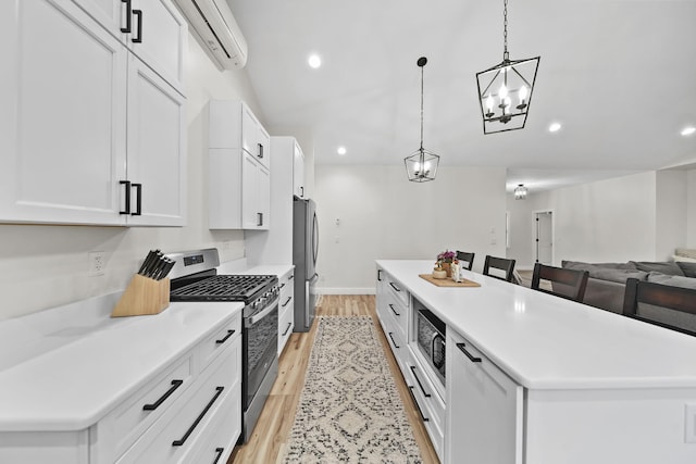7450 Sears Rd, Horton, MI 49246 - kitchen with a kitchen island, appliances with stainless steel finishes, white cabinets, and a wall mounted air conditioner