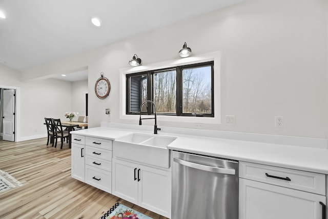 7450 Sears Rd, Horton, MI 49246 - kitchen featuring light countertops, stainless steel dishwasher, light wood-type flooring, and a sink