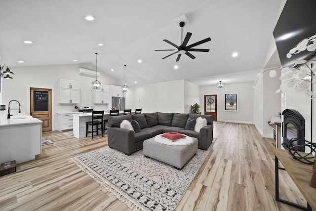 7450 Sears Rd, Horton, MI 49246 - living room with high vaulted ceiling, a tile fireplace, light wood-style flooring, and recessed lighting