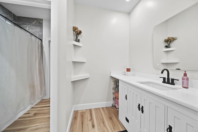 7450 Sears Rd, Horton, MI 49246 - full bathroom featuring a shower with shower curtain, vanity, baseboards, and wood finished floors