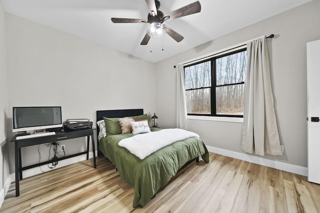 7450 Sears Rd, Horton, MI 49246 - bedroom with a ceiling fan, baseboards, and wood finished floors