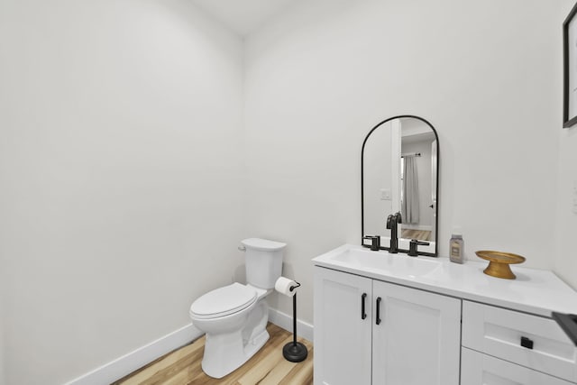 7450 Sears Rd, Horton, MI 49246 - bathroom with wood finished floors, vanity, toilet, and baseboards